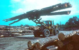 Tractor carrying logs through yard in unstable manner Tractor carrying logs through yard in unstable manner